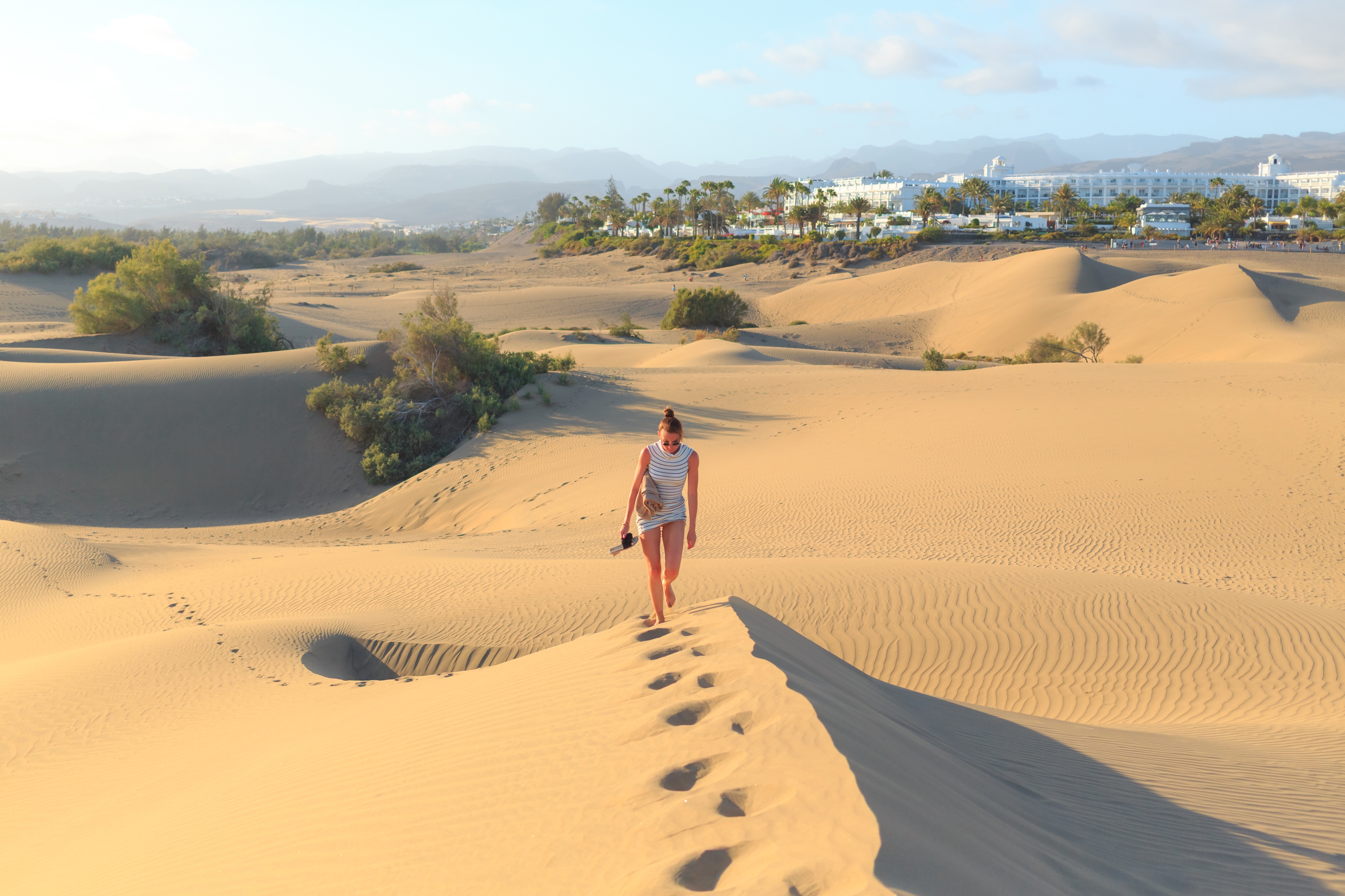 A,Traveler,Strides,Across,Golden,Sand,Dunes,In,Fuerteventura,,Enjoying